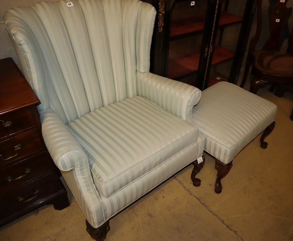A Queen Anne I style wing armchair on shell carved cabriole forelegs, W.83cm, H.101cm and a matching stool